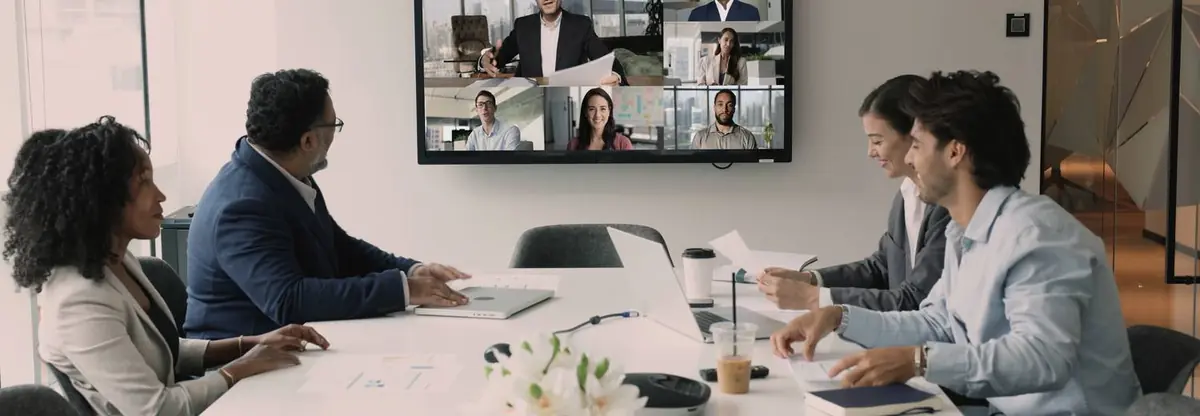 A leadership team meeting with remote colleagues joining on screen