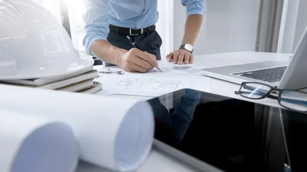 An estimator marking up construction drawings